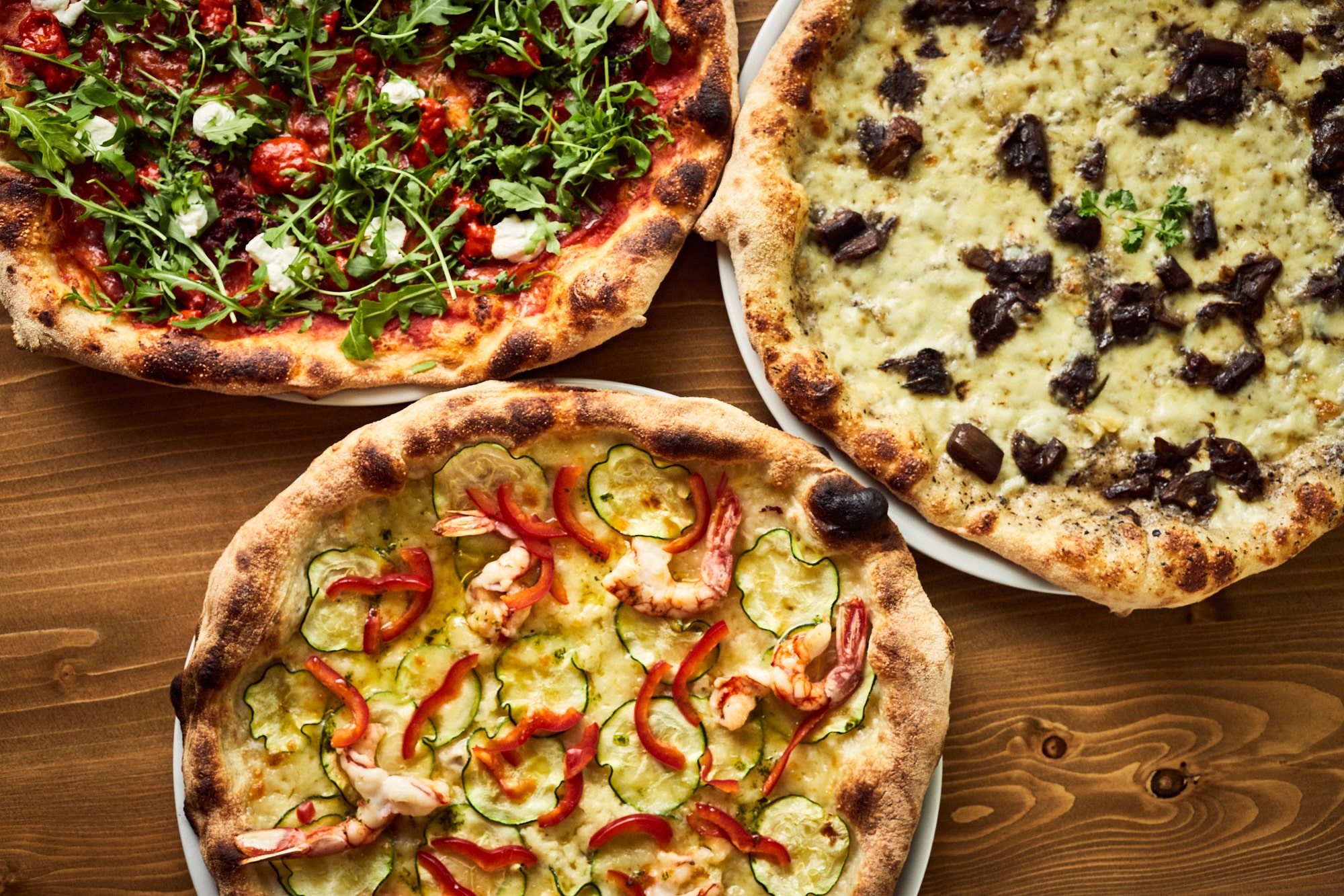 Authentic, thin, crispy, three Italian pizzas with different toppings.